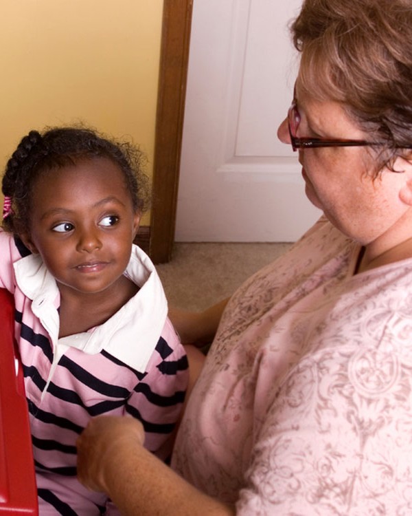 A young girl listens to her female OT.